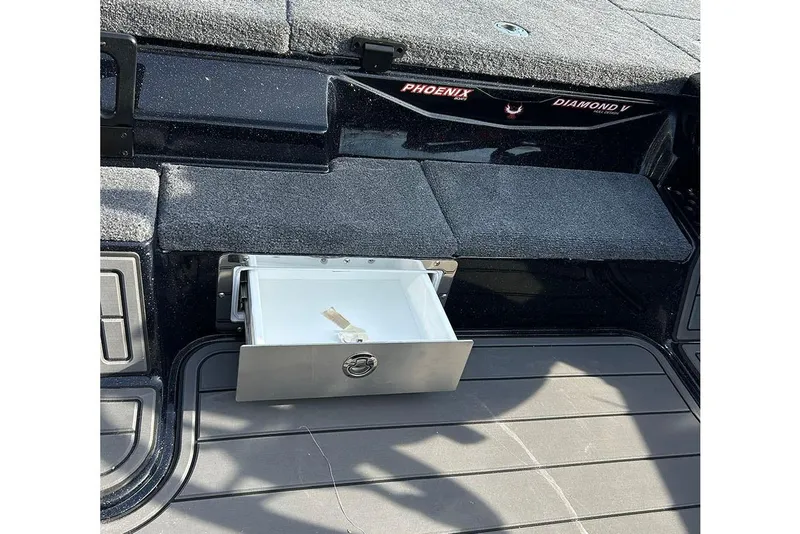 Slide: The Image of Open storage compartment in 2026 Phoenix 921 Elite X boat interior. - 23