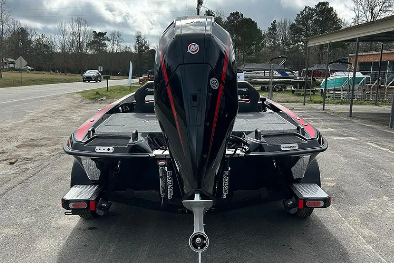 Slide: The Image of 2026 Phoenix 921 Elite X boat, rear view, parked outdoors on a cloudy day. - 24