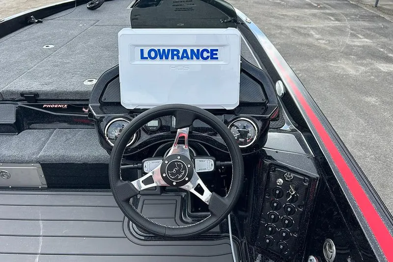 Slide: The Image of 2026 Phoenix 921 Elite X boat dashboard with Lowrance display and steering wheel. - 26
