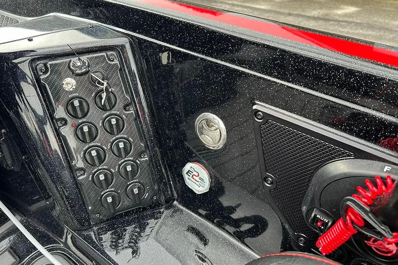 Slide: The Image of Control panel of 2026 Phoenix 921 Elite X boat with switches and key. - 27