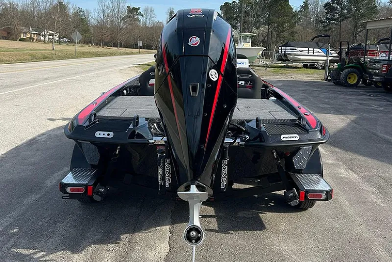 Slide: The Image of 2026 Phoenix 921 Elite X boat with powerful outboard motor, parked on a sunny day. - 3