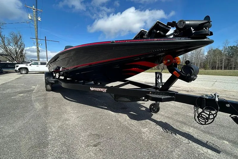 Slide: The Image of 2026 Phoenix 921 Elite X boat on trailer under clear blue sky. - 34
