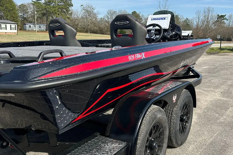 Slide: The Image of 2026 Phoenix 921 Elite X boat with sleek black and red design on a trailer. - 5
