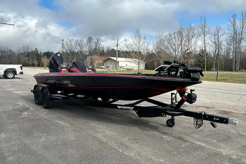Slide: The Image of 2026 Phoenix 921 Elite X boat on trailer in parking lot, overcast sky. - 7