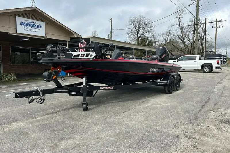 Slide: The Image of 2026 Phoenix 921 Elite X boat on trailer outside Berkeley Outdoors store. - 8