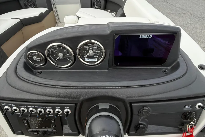 Slide: The Image of Dashboard of 2026 Berkshire 24 RFX CTS boat with gauges and Simrad display. - 13
