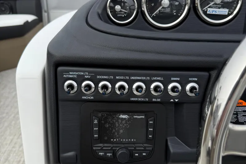 Slide: The Image of Control panel of 2026 Berkshire 24 RFX CTS boat with switches and gauges. - 14