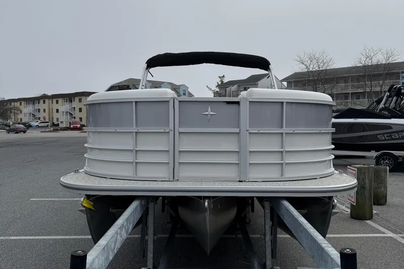 Slide: The Image of 2026 Berkshire 24 RFX CTS pontoon boat on trailer in parking lot. - 3