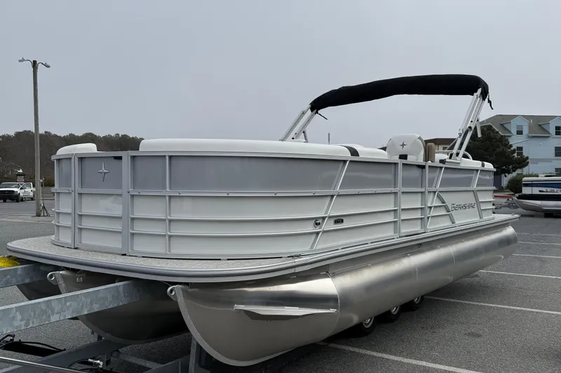 Slide: The Image of 2026 Berkshire 24 RFX CTS pontoon boat parked in a lot, side view. - 4