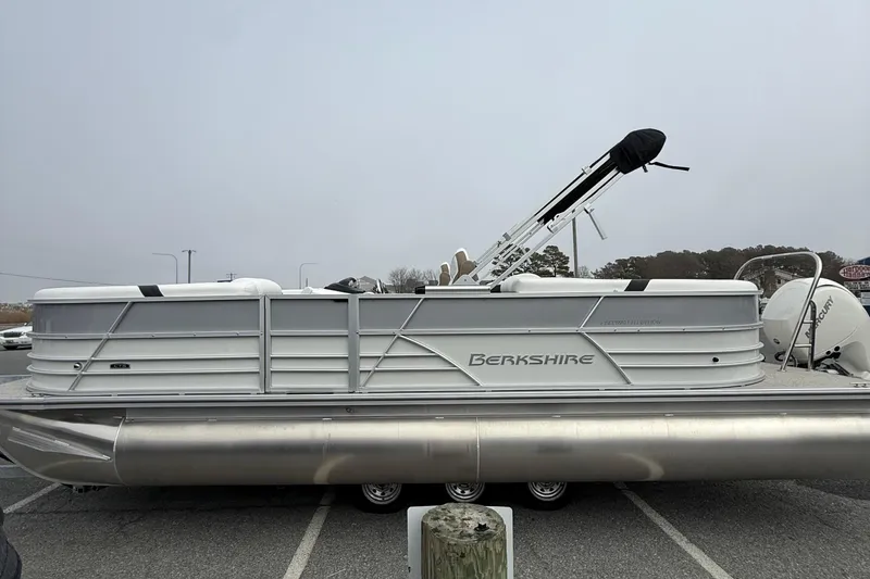 Slide: The Image of 2026 Berkshire 24 RFX CTS pontoon boat parked on a lot, side view. - 5