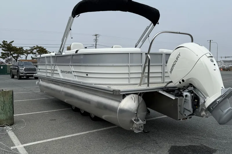 Slide: The Image of 2026 Berkshire 24 RFX CTS pontoon boat with Mercury engine in parking lot. - 6