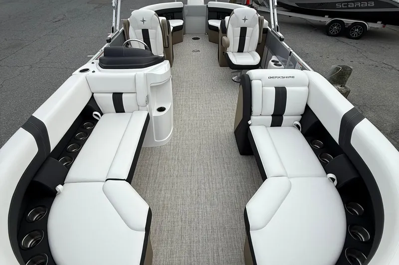 Slide: The Image of 2026 Berkshire 24 RFX CTS pontoon boat interior with luxurious seating and cup holders. - 9