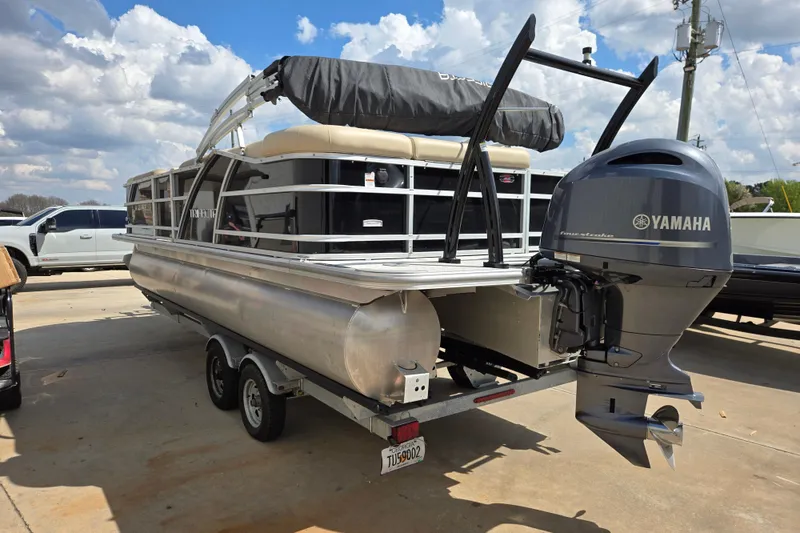 Slide: The Image of 2021 Trifecta SS 23C 2.75 pontoon boat with Yamaha outboard motor on trailer. - 4