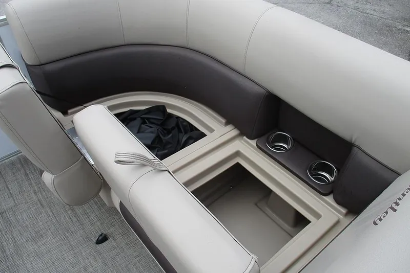 Slide: The Image of 2026 Bentley Pontoons Legacy 200 Navigator interior seating with storage and cup holders. - 17