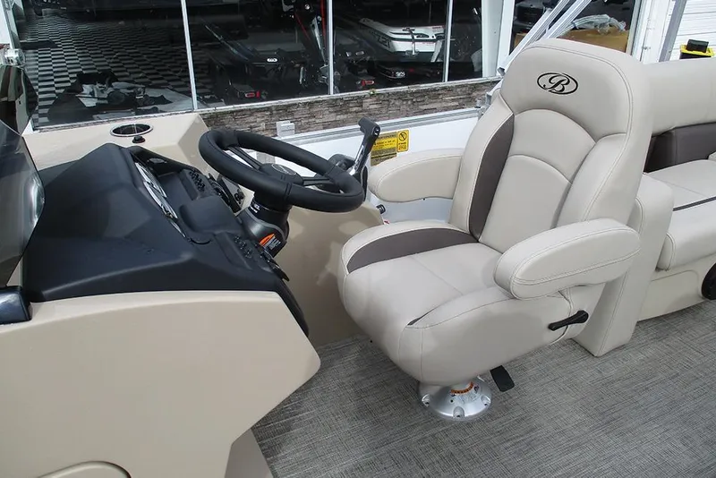 Slide: The Image of 2026 Bentley Pontoons Legacy 200 Navigator helm with luxurious captain's chair and steering wheel. - 29