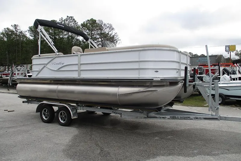 Slide: The Image of 2026 Bentley Pontoons Legacy 200 Navigator on trailer, parked outdoors. - 5