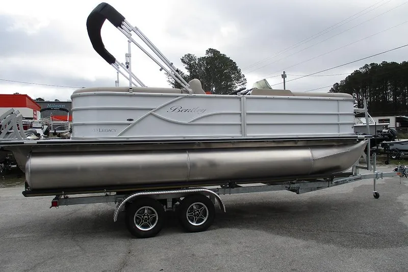 Slide: The Image of 2026 Bentley Pontoons Legacy 200 Navigator on trailer, displayed outdoors. - 6