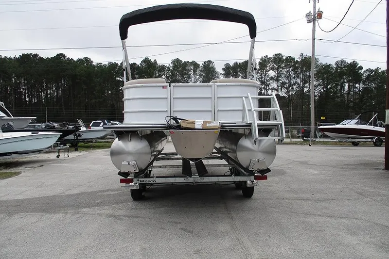 Slide: The Image of 2026 Bentley Pontoons Legacy 200 Navigator on trailer, rear view in outdoor setting. - 8