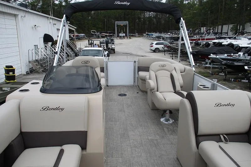 Slide: The Image of 2026 Bentley Pontoons Legacy 200 Navigator interior with luxurious seating and helm. - 9