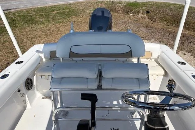 Slide: The Image of 2015 Sportsman Heritage 211 Center Console boat interior with steering wheel and seating. - 10