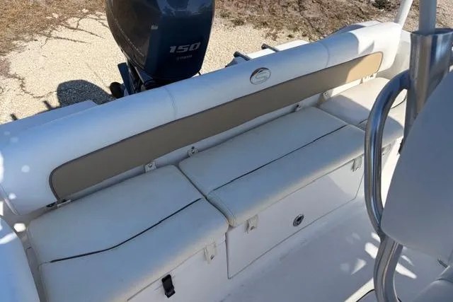 Slide: The Image of 2015 Sportsman Heritage 211 Center Console boat with cushioned seating and 150 horsepower engine. - 11