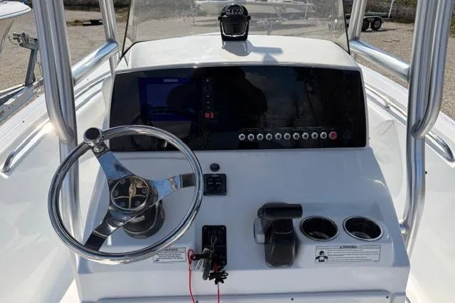 Slide: The Image of 2015 Sportsman Heritage 211 Center Console dashboard with steering wheel and controls. - 13