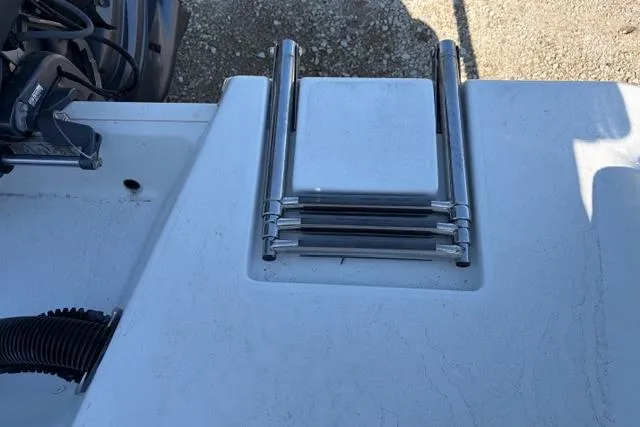 Slide: The Image of 2015 Sportsman Heritage 211 Center Console boat with folded swim ladder. - 15