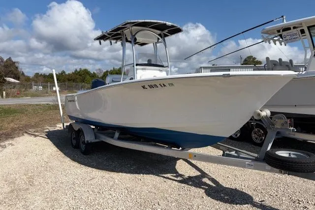 Slide: The Image of 2015 Sportsman Heritage 211 Center Console boat on trailer, parked outdoors. - 2
