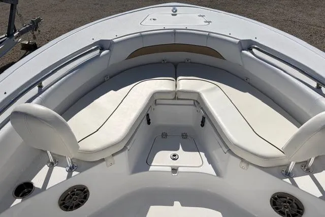 Slide: The Image of 2015 Sportsman Heritage 211 Center Console boat with white cushioned seating area. - 6