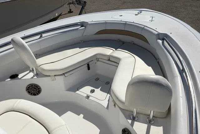 Slide: The Image of 2015 Sportsman Heritage 211 Center Console boat with white cushioned seating. - 7
