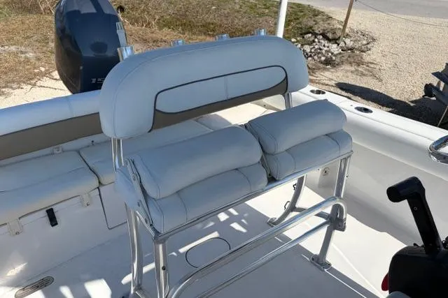 Slide: The Image of 2015 Sportsman Heritage 211 Center Console boat interior with cushioned seating and console. - 9
