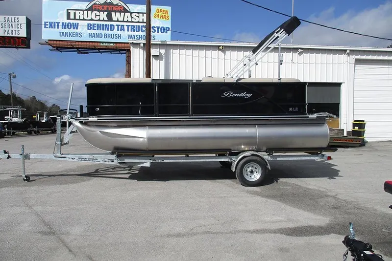The Image of 2026 Bentley Pontoons LE 180 CR on trailer, parked outside dealership. - 1