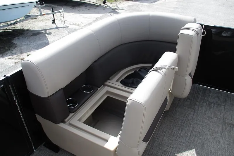 Slide: The Image of 2026 Bentley Pontoons LE 180 CR interior seating with storage and cup holders. - 14