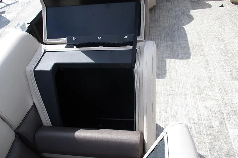 Slide: The Image of 2026 Bentley Pontoons LE 180 CR interior storage compartment with open lid. - 18