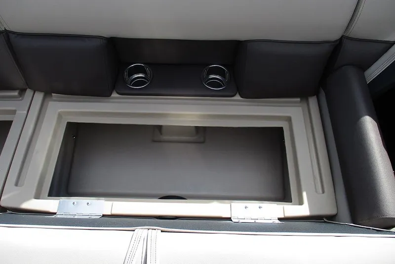 Slide: The Image of 2026 Bentley Pontoons LE 180 CR storage compartment with cup holders and cushioned seating. - 19