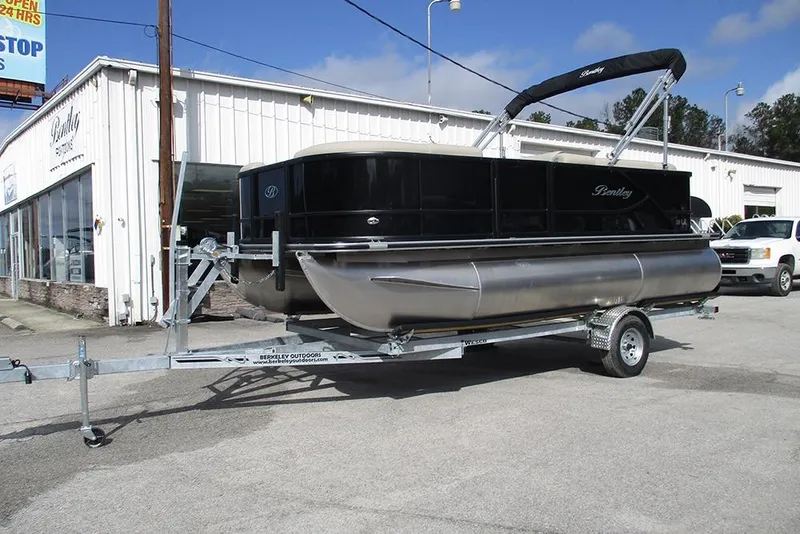 Slide: The Image of 2026 Bentley Pontoons LE 180 CR on trailer outside dealership. - 3
