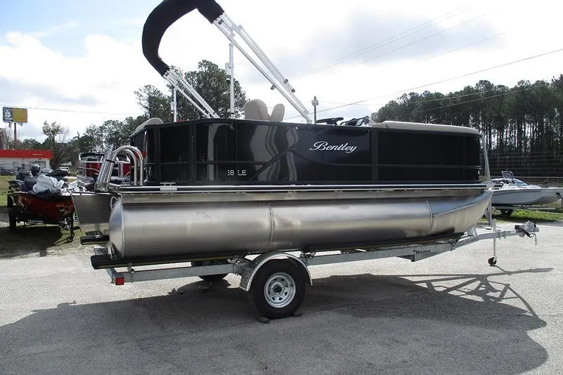 Slide: The Image of 2026 Bentley Pontoons LE 180 CR on trailer, sleek design, outdoor setting. - 7