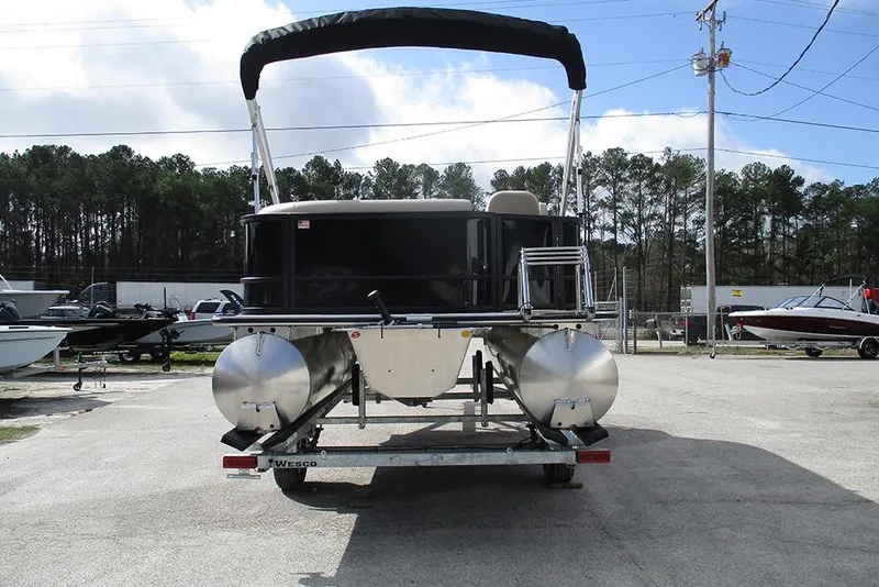 Slide: The Image of 2026 Bentley Pontoons LE 180 CR on trailer, parked outdoors under a cloudy sky. - 8