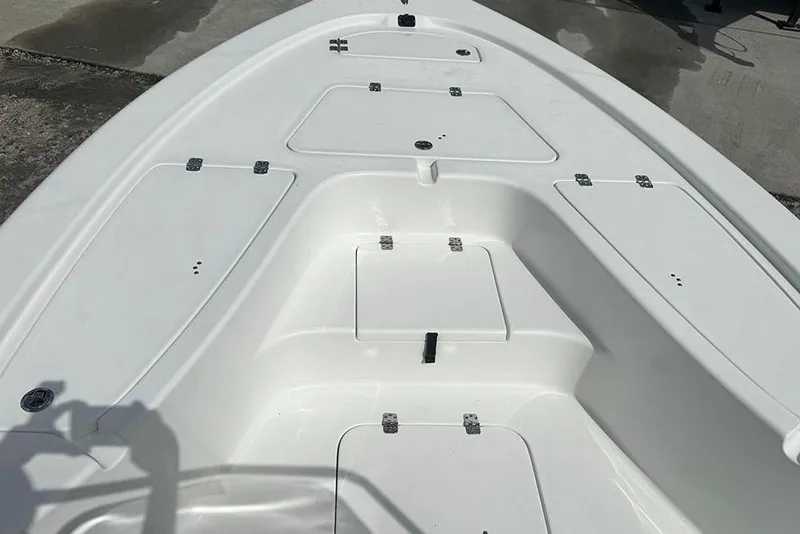 Slide: The Image of 2026 Sea Pro 230 Bay boat deck with multiple storage compartments. - 11