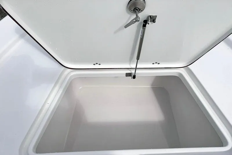 Slide: The Image of Open storage compartment on 2026 Sea Pro 230 Bay boat, featuring hydraulic lift support. - 17