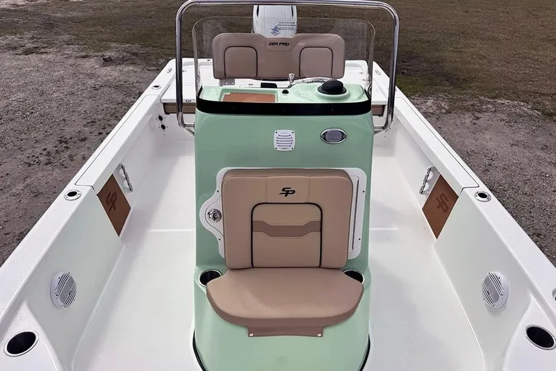 Slide: The Image of 2026 Sea Pro 230 Bay boat interior with mint green console and tan seating. - 20