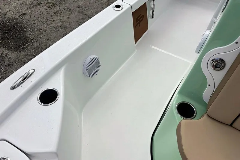 Slide: The Image of 2026 Sea Pro 230 Bay boat interior with cup holders and seating. - 24