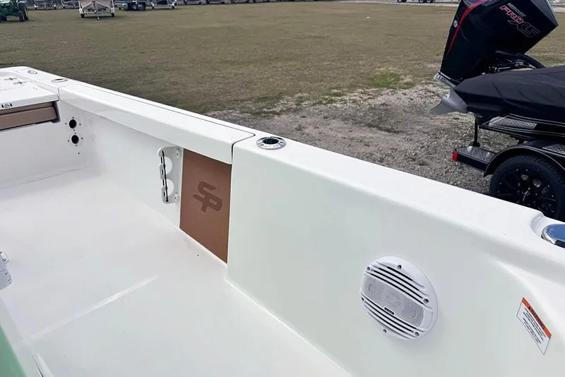 Slide: The Image of 2026 Sea Pro 230 Bay boat interior with speaker and storage compartment. - 27