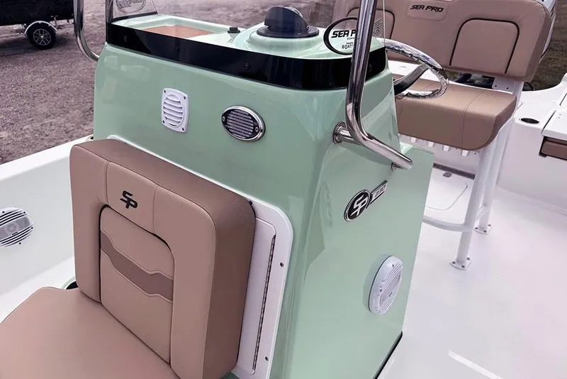Slide: The Image of 2026 Sea Pro 230 Bay boat interior with mint green console and tan seating. - 28