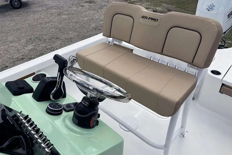 Slide: The Image of 2026 Sea Pro 230 Bay boat interior with beige seating and modern controls. - 30