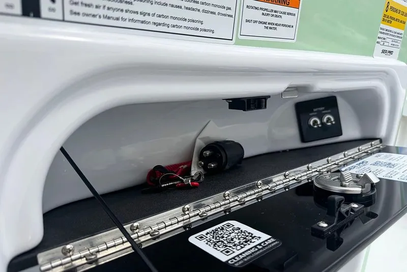 Slide: The Image of Control panel of 2026 Sea Pro 230 Bay boat with safety warnings and QR code. - 33