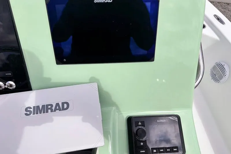 Slide: The Image of 2026 Sea Pro 230 Bay dashboard featuring Simrad and Audison electronics. - 35