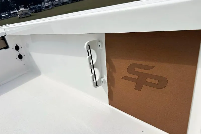 Slide: The Image of 2026 Sea Pro 230 Bay boat interior detail with logo and storage compartment. - 37