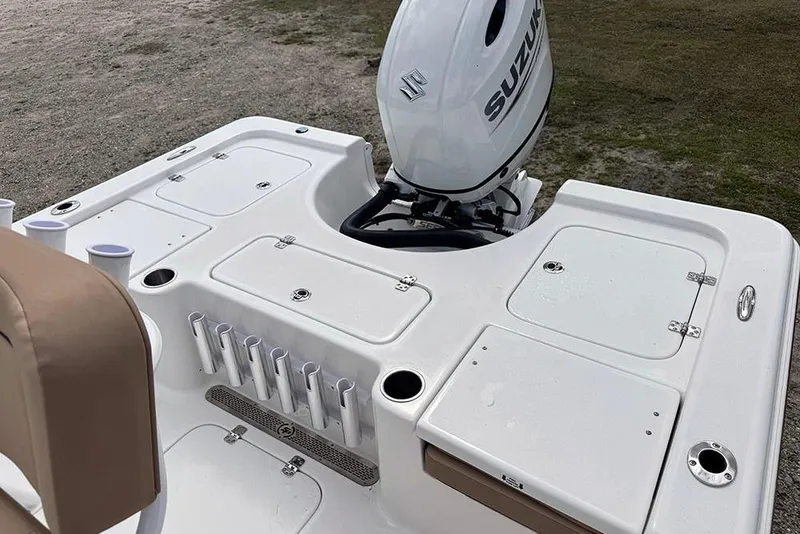 Slide: The Image of 2026 Sea Pro 230 Bay boat with Suzuki outboard motor, featuring multiple storage compartments. - 38