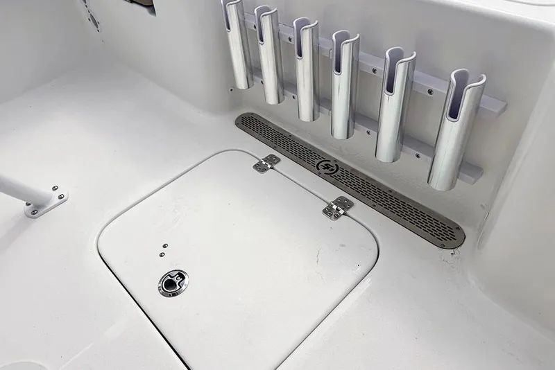 Slide: The Image of 2026 Sea Pro 230 Bay boat interior with rod holders and storage hatch. - 39